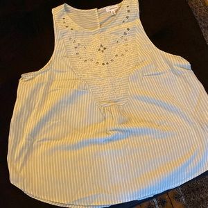 Green and white striped sleeveless women’s top with embroidered design bib